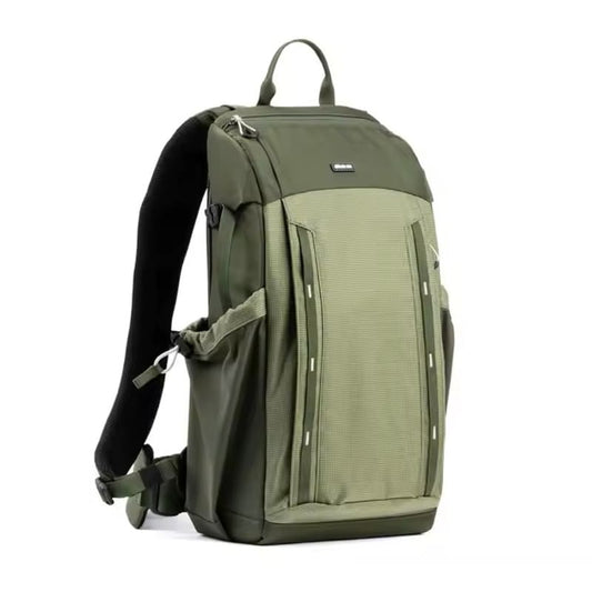 Customizable green backpack for creatives, featuring multi-compartment layout and expandable water bottle or tripod pocket.