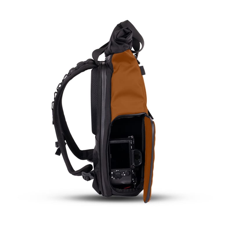 Compact photographer backpack featuring quickdraw side access and magnetic tote handles, customizable for private label clients.