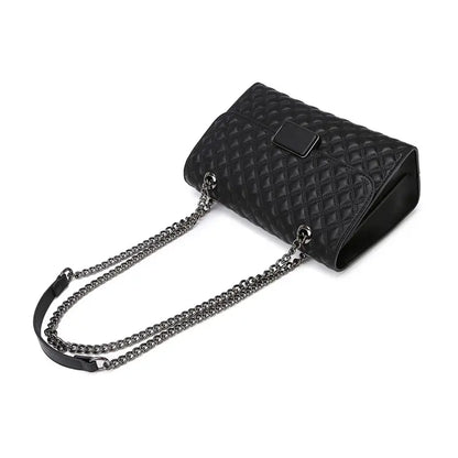 Quilted handbag flat lay with chain strap