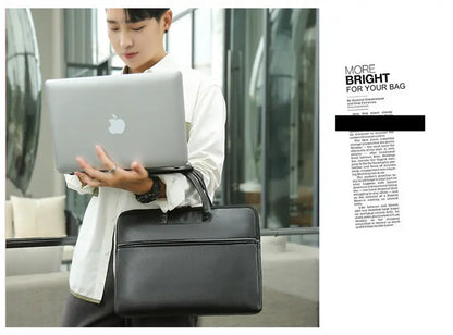 Man carrying black briefcase while holding laptop - shows size comparison