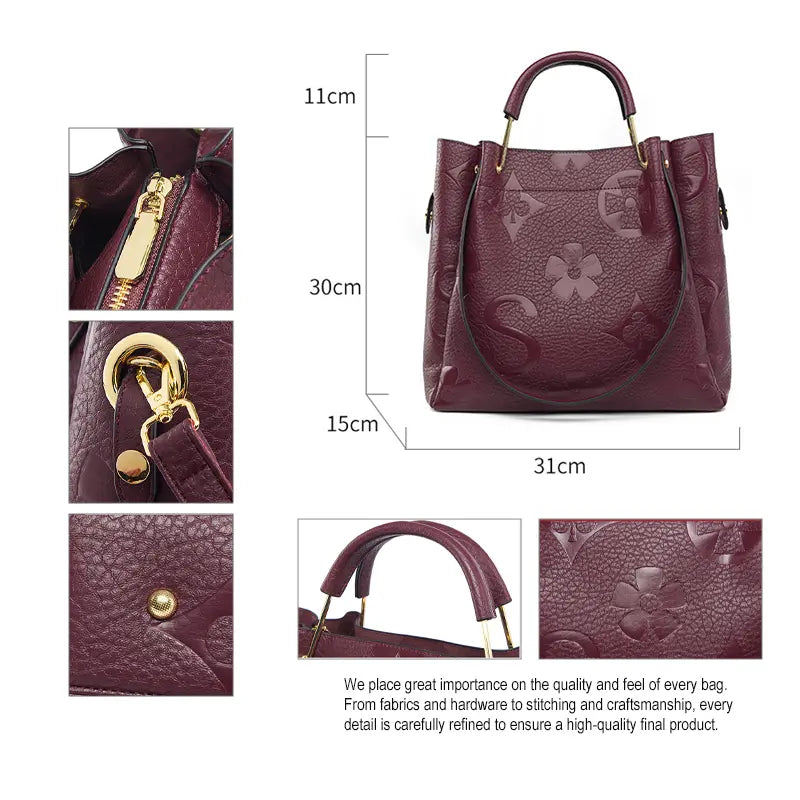Floral embossed tote bag gold hardware zip pull and strap clasp detail